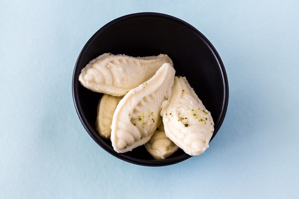 Durga Puja,Diwali festival special Bengali sweet called Shankh Sandesh or Sondesh or Shondesh on blue background.